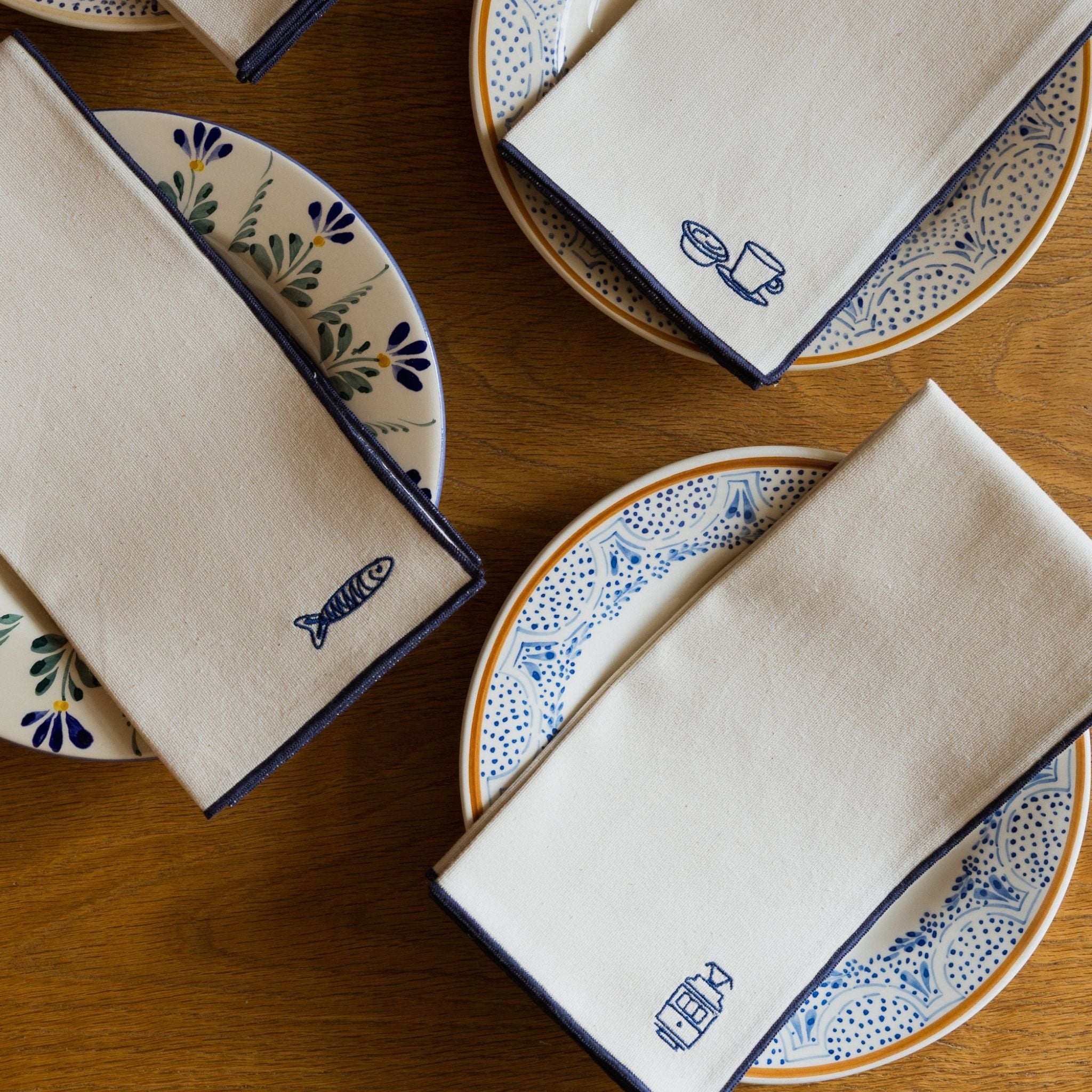 Nazaré ecru cotton table linen with embroidered Portugal-inspired motifs